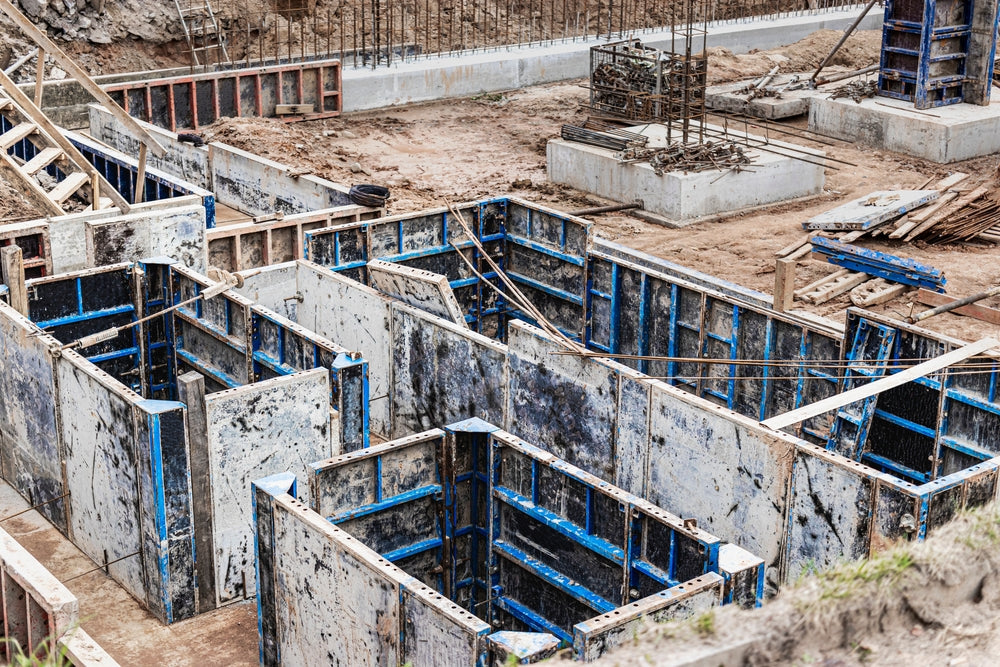 base plate. pit formation of grillage is completed. Forms formwork vertical structures of lower level underground parking. Raft foundation is top pile, pier foundation. Home construction