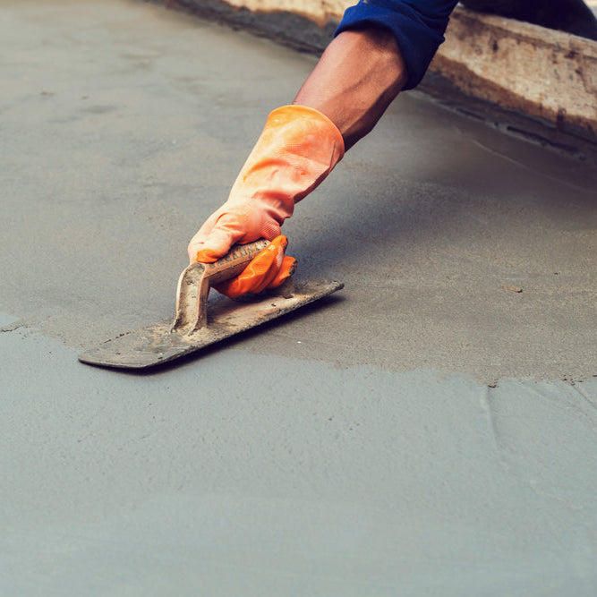 image of a man troweling concrete to achieve a smooth finish