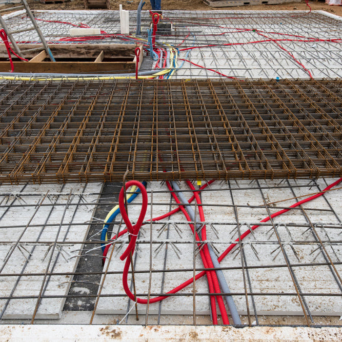 Wire mesh reinforcement installed on a concrete slab before the concrete pour.